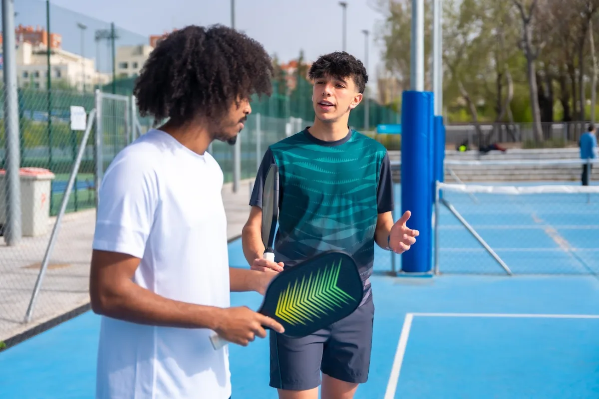 Pickleball instructor teaching someone how to play