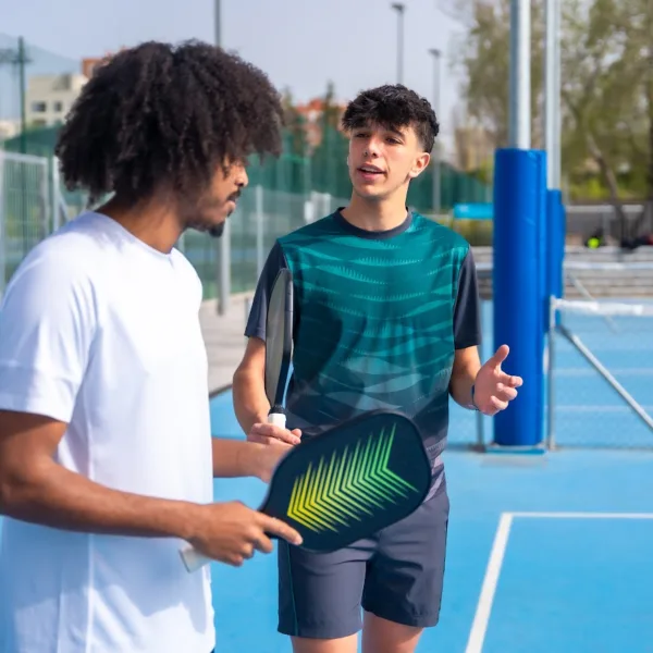 Pickleball instructor teaching someone how to play