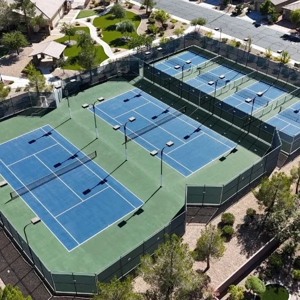 Tennis courts age visibly: fading color, hairline cracking, low spots where water pools, and a surface that no longer grips the way it used to. Before assuming a full rebuild is necessary, it's worth understanding what resurfacing actually involves, what drives its cost, and when a rebuild is genuinely the better call. What Tennis Court Resurfacing Involves Resurfacing is not just a fresh coat of paint. A proper resurfacing project includes: Surface assessment — checking for structural cracking, drainage issues, and base integrity before any coating is applied. Crack repair — filling and treating cracks with flexible fillers designed to move with the surface rather than re-crack immediately. Resurfacer application — a textured coat that fills minor surface irregularities and creates a uniform base for color coats. Color coating — typically two coats of acrylic color, applied evenly across the full court. Line striping — precise regulation lines repainted in durable, UV-resistant paint. Done correctly, resurfacing restores both the appearance and playability of a court that has aged but still has a structurally sound base underneath. What Drives Resurfacing Cost Court condition. A court with only cosmetic fading and minor cracking costs less to resurface than one with extensive cracking that requires significant crack repair before coating can even begin. Court size. Standard singles/doubles courts have a fixed footprint, but multi-court facilities scale cost accordingly. Number of coats and system type. Standard acrylic resurfacing costs less than cushioned acrylic systems, which add a rubberized layer for extra shock absorption. Access and site conditions. Courts with easy equipment access cost less to resurface than those requiring extensive material transport or site prep. Line striping complexity. Standard tennis lines cost less than multi-sport overlays combining tennis with pickleball or other sport lines on the same court. Resurfacing vs. Rebuild: How to Decide Resurfacing makes sense when: The base (concrete or asphalt) is structurally sound with no major settling or heaving. Cracking is limited to surface-level or minor structural cracks that can be properly treated. Drainage and slope are still functioning correctly, water isn't pooling on the court. A rebuild is the better call when: The base shows significant heaving, settling, or structural failure that resurfacing can't fix. Drainage problems are severe enough that water regularly pools, indicating the underlying slope is wrong. Extensive, widespread cracking suggests the base itself has failed rather than just the surface coating. Resurfacing costs meaningfully less than a full rebuild, but only delivers lasting results when the base underneath is actually sound. A resurfacing job over a failing base is a short-term fix that will need to be redone within a couple of years. Why Professional Assessment Matters The biggest cost mistake we see is property owners resurfacing a court that actually needed a rebuild, spending money on a coating system that fails again within a season or two because the underlying problem was never addressed. Our team assesses the base and drainage first, then recommends resurfacing or rebuild honestly, even when resurfacing would be the easier sale. FAQ How much does it typically cost to resurface a tennis court? Cost depends on court condition, size, and the surface system chosen. We provide a detailed, itemized quote after assessing your court in person. How often should a tennis court be resurfaced? Most tennis courts benefit from resurfacing every four to eight years, depending on usage intensity and sun exposure. Can cracks be fixed without a full rebuild? Yes, in many cases. Surface-level and minor structural cracks can be treated with flexible crack fillers as part of a resurfacing project, provided the underlying base is still sound. How do I know if I need resurfacing or a full rebuild? The deciding factor is base condition. If the concrete or asphalt base is structurally sound with functioning drainage, resurfacing is usually sufficient. Significant heaving, settling, or drainage failure points to a rebuild. How long does a tennis court resurfacing project take? Most resurfacing projects take about one to two weeks, including crack repair, coating, curing time, and striping. Does resurfacing include new line striping? Yes, standard resurfacing packages include fresh, precise line striping as part of the process. This page is part of our tennis services alongside our tennis court construction company page. Ready to assess your court? Get a quote from Legendary Sport Construction today.